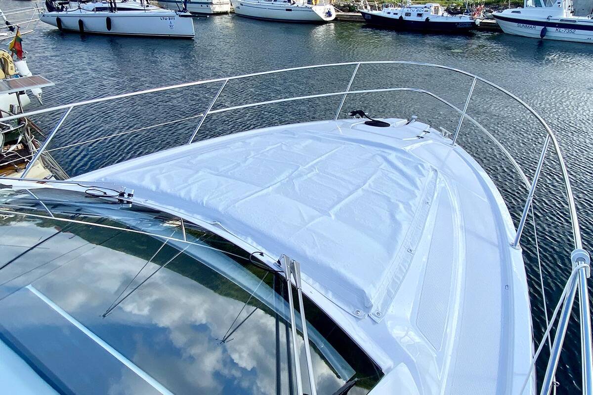 Sunbathing cushions on bow with covers