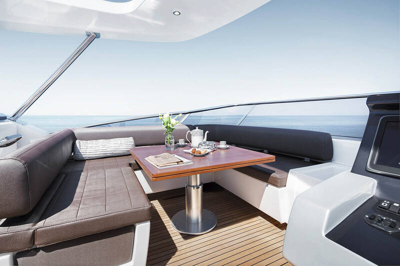 Seating area next to helm station on fly convertible in sunbathing area